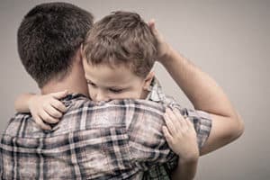 father hugging son and saying goodbye before going to rehab